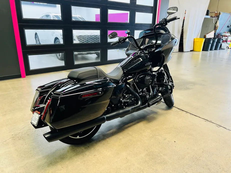 Black touring motorcycle in the shop bay